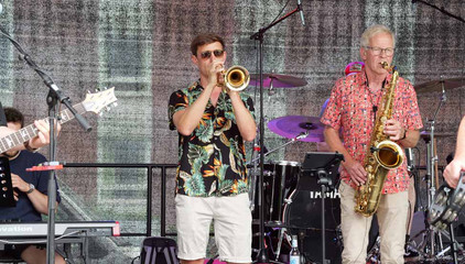 Ein Trompeter und ein Saxophonist spielen in bunten Hemden auf der Musikbühne beim Sommerfest 2026 auf dem Gesundheitscampus Volksdorf des Evangelischen Amalie Sieveking Krankenhauses, der Residenz am Wiesenkamp, des Feierabendhauses Volksdorf und der Albertinen Kindertagesstätte Volksdorf. Ein Trompeter und ein Saxophonist spielen in bunten Hemden auf der Musikbühne beim Sommerfest 2026 auf dem Gesundheitscampus Volksdorf des Evangelischen Amalie Sieveking Krankenhauses, der Residenz am Wiesenkamp, des Feierabendhauses Volksdorf und der Albertinen Kindertagesstätte Volksdorf.